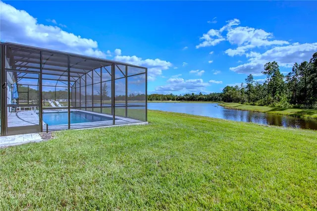 swimming pool with seating space and yard