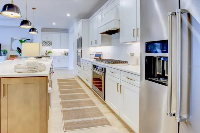 a kitchen with white cabinets and appliances