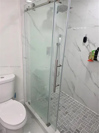 a bathroom with a toilet and a shower