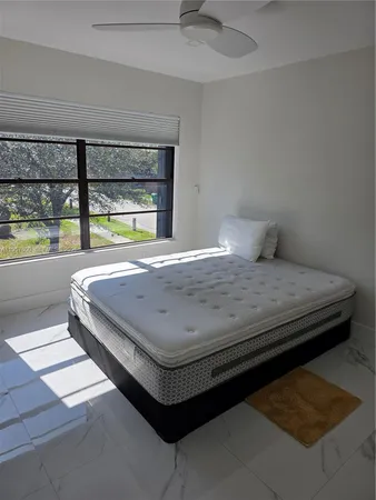 a bedroom with a bed and window