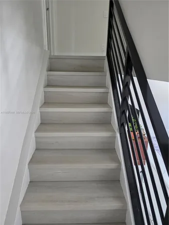 a view of staircase with white walls