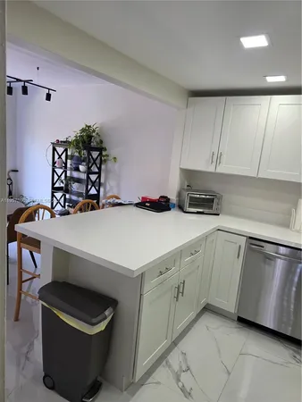 a kitchen with a sink cabinets and window