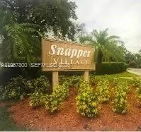 a street sign that is sitting in the middle of a yard