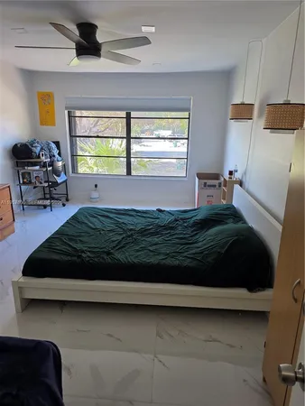 a bed sitting in a bedroom next to a window