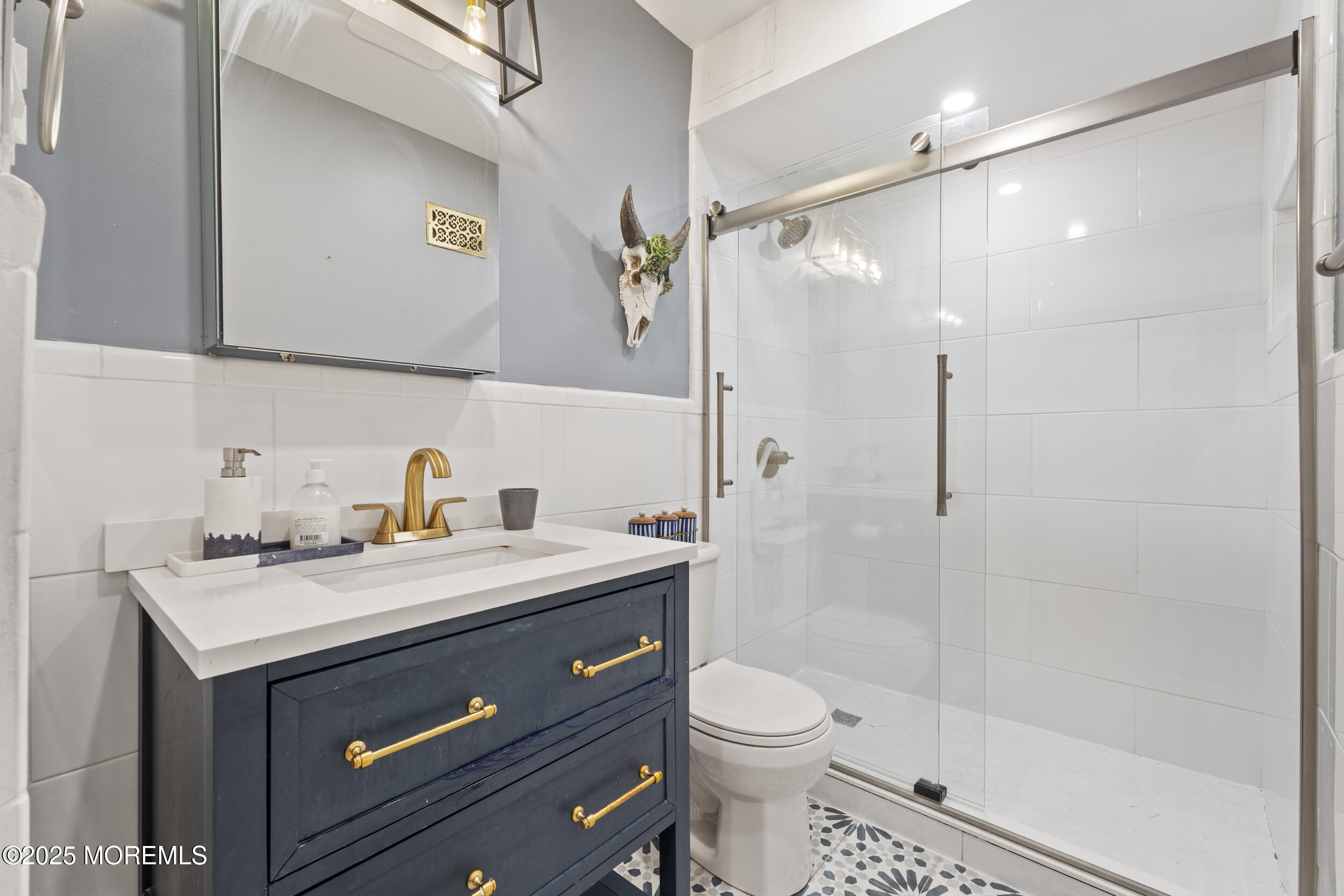 200 Portland Road, Unit B22 Highlands, NJ 07732 - Photo 18 of 35 a bathroom with a sink a toilet a mirror and shower