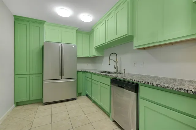 a kitchen with a refrigerator and a sink