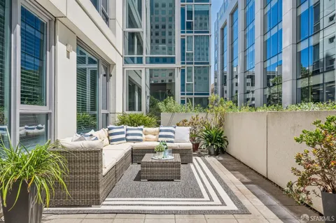 a view of a chairs and tables in the back yard of the house
