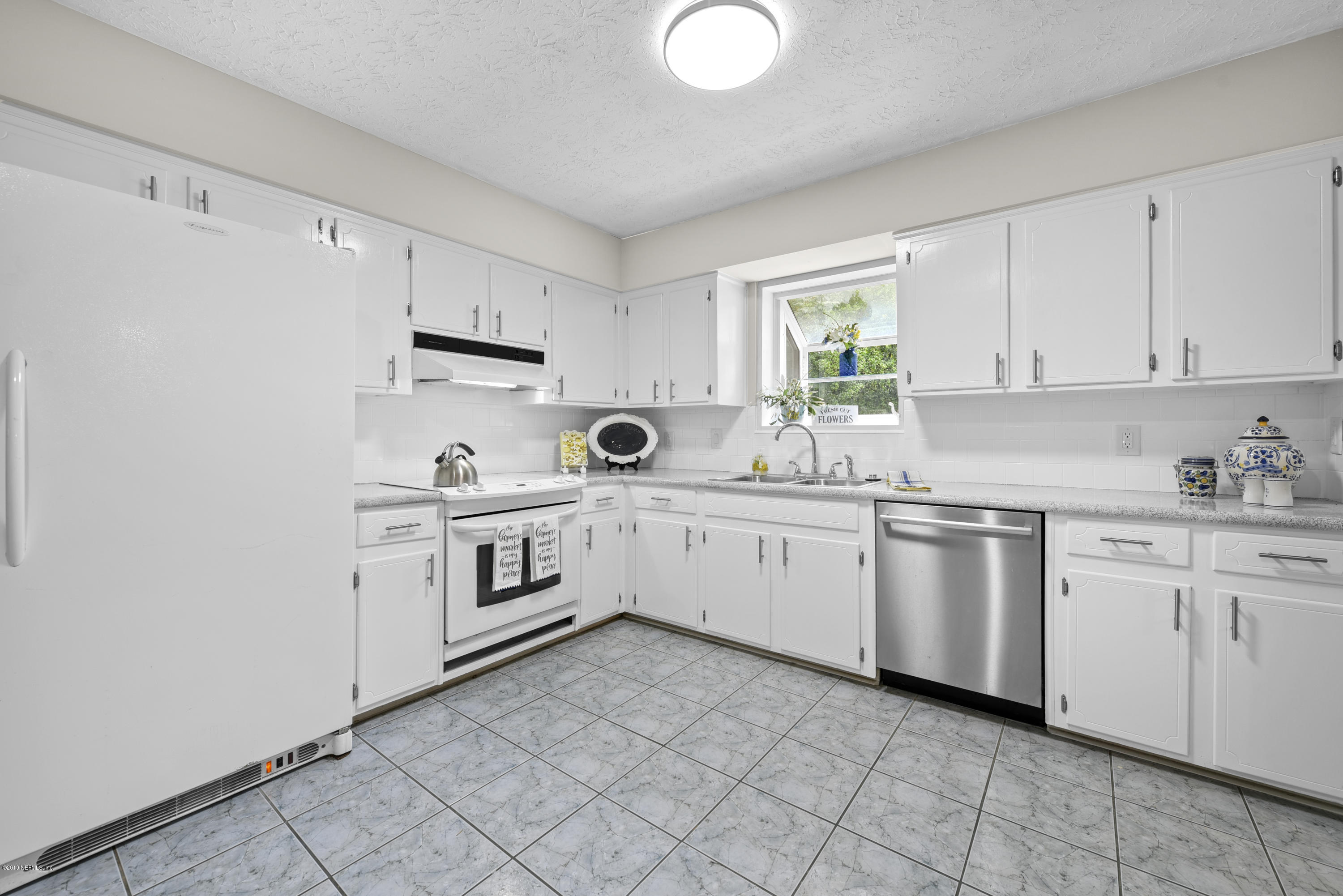 1276 Arbor Circle Orange Park, FL 32073 - Photo 11 of 23 a kitchen with granite countertop white cabinets and white appliances