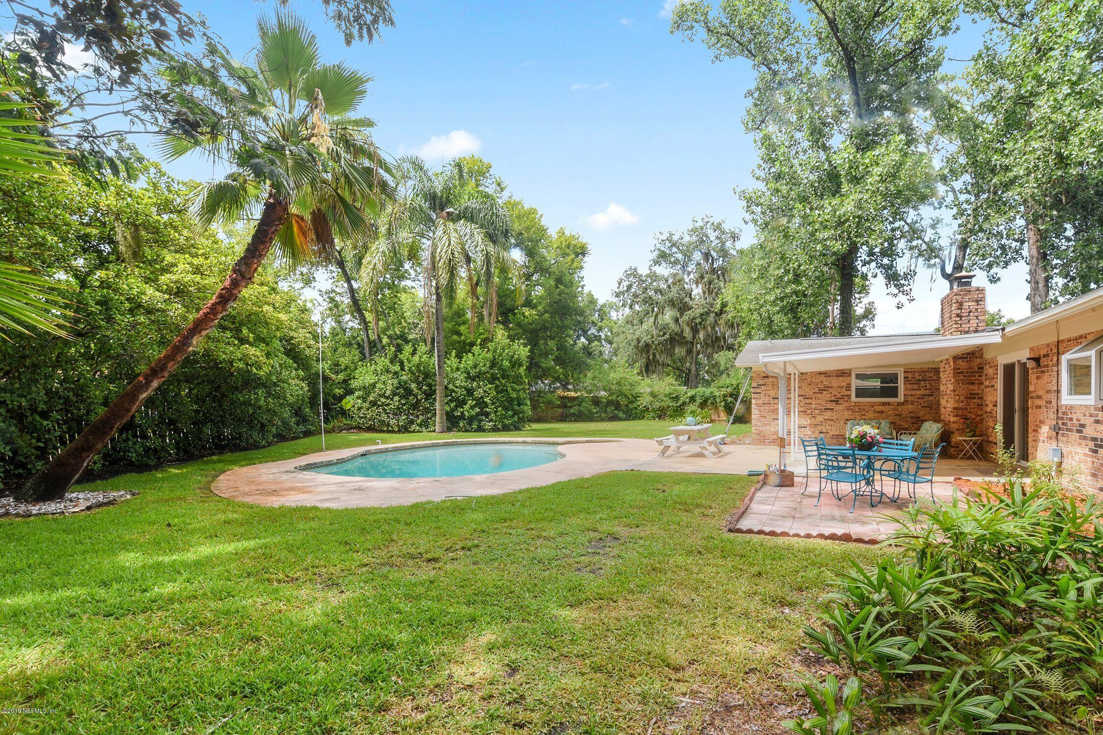 1276 Arbor Circle Orange Park, FL 32073 - Photo 23 of 23 a view of a backyard with table and chairs potted plants and large tree