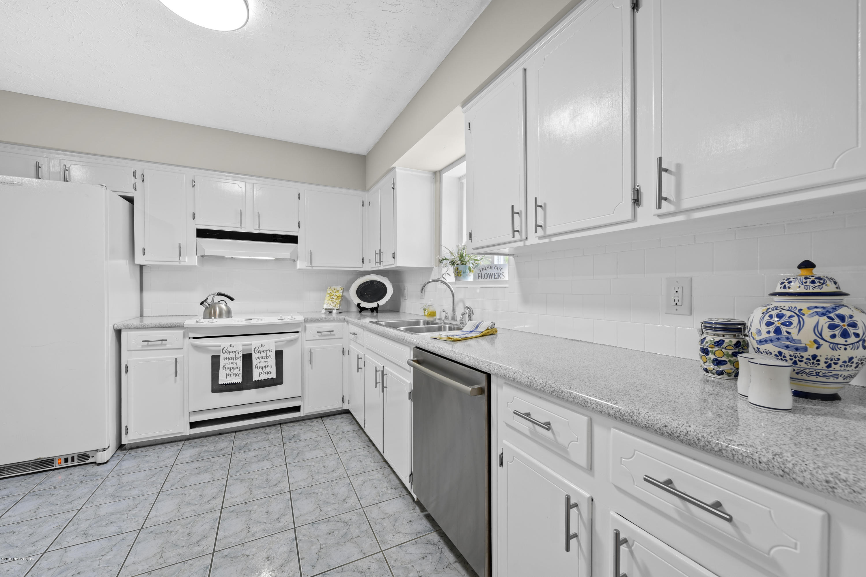 1276 Arbor Circle Orange Park, FL 32073 - Photo 10 of 23 a kitchen with white cabinets and white appliances