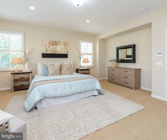 a bedroom with a large bed and a flat screen tv