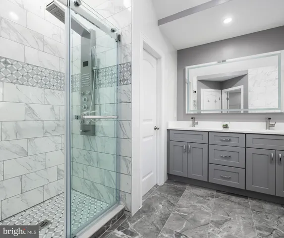 a spacious bathroom with a shower sink and mirror