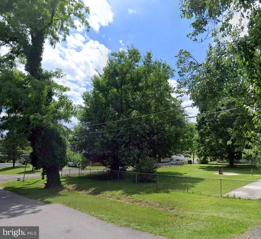 an aerial view of a house a yard and a fountain