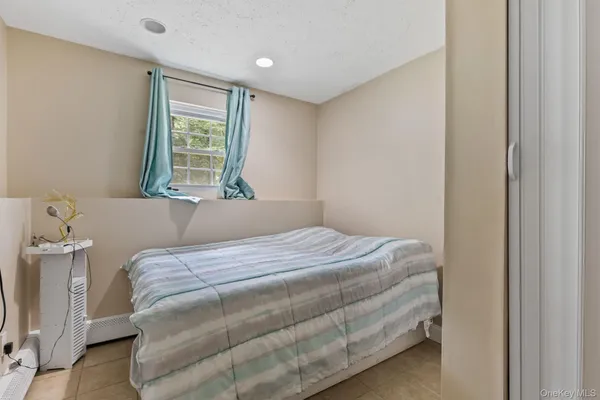 a bedroom with a bed and painting on the wall
