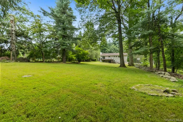 a view of a house with a yard and sitting area