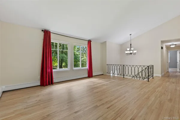 a view of staircase with railing and wooden floor