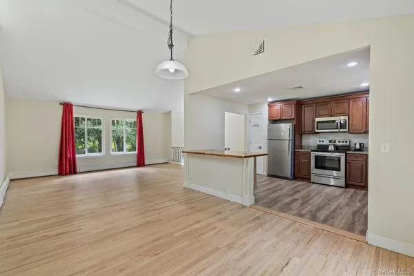 a view of a kitchen with a sink and wooden floor