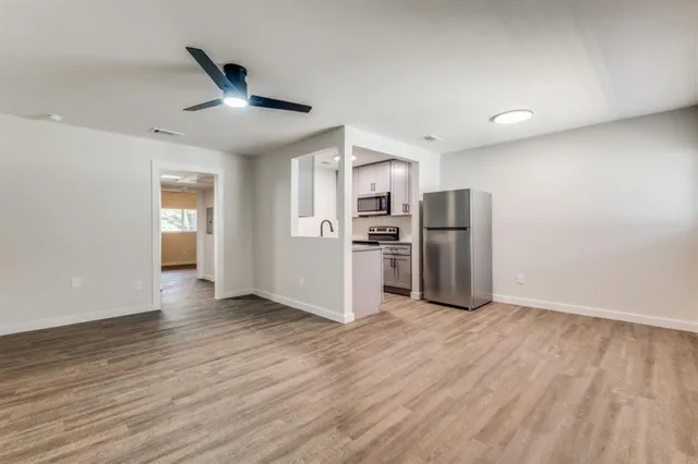 a view of kitchen with stainless steel appliances refrigerator and microwave