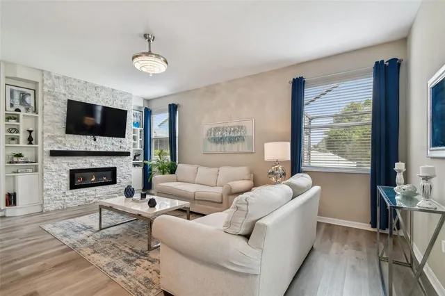 a living room with furniture and view of kitchen