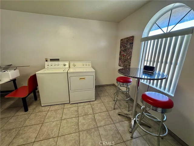 a living room with furniture a rug and white walls