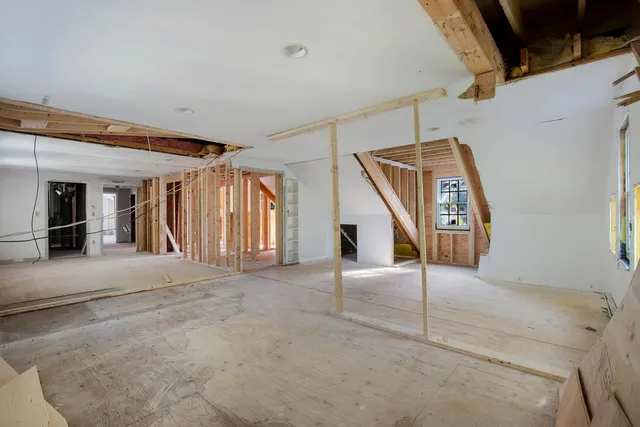 a view of a hallway with a door and wooden floor