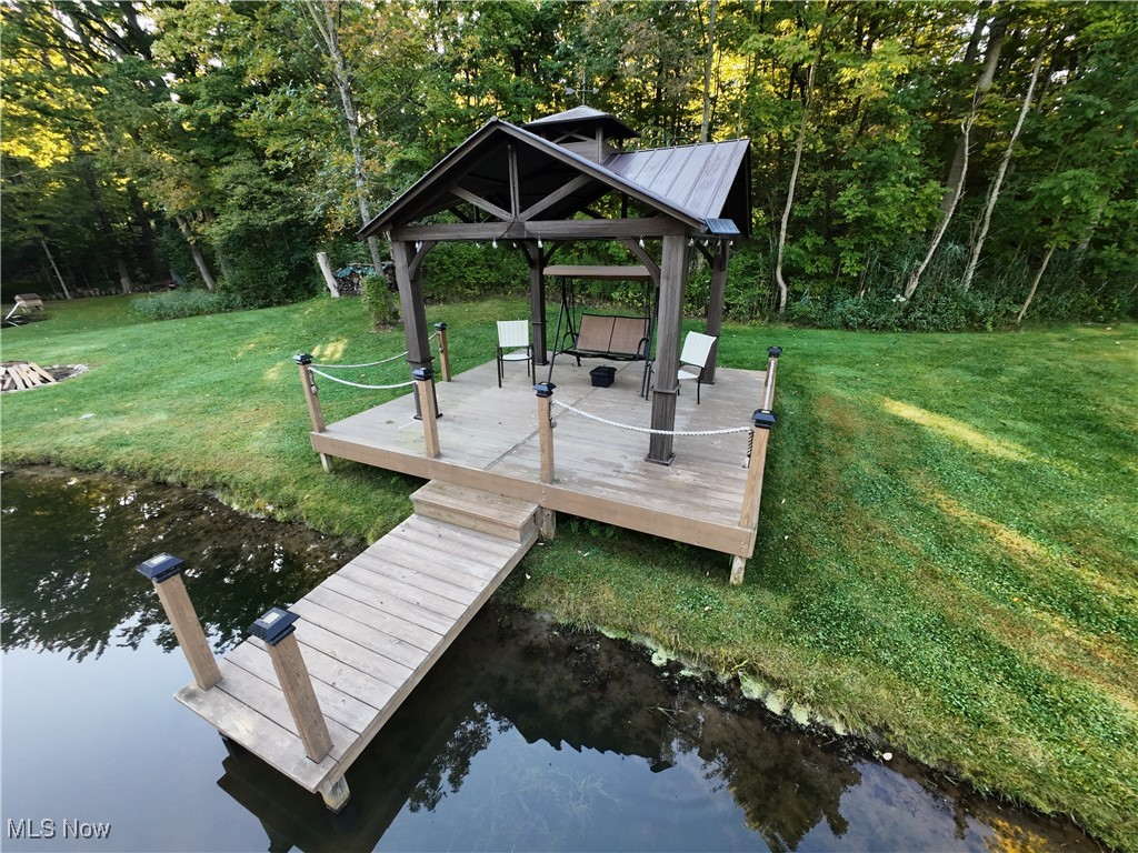5232 Emerson Road Madison, OH 44057 - Photo 39 of 48 Dock area featuring a water view and a yard