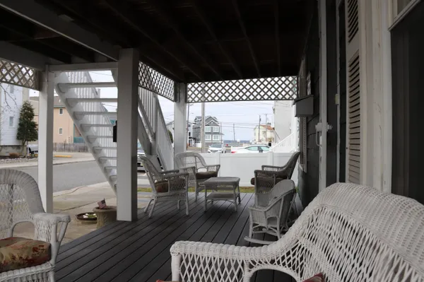 a balcony with furniture and wooden floor