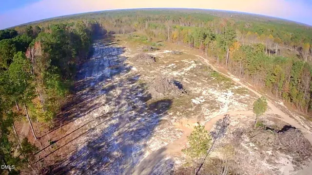 a view of a yard with wooden fence