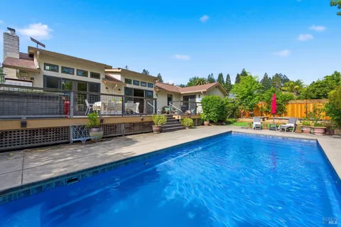 a view of a swimming pool with outdoor seating