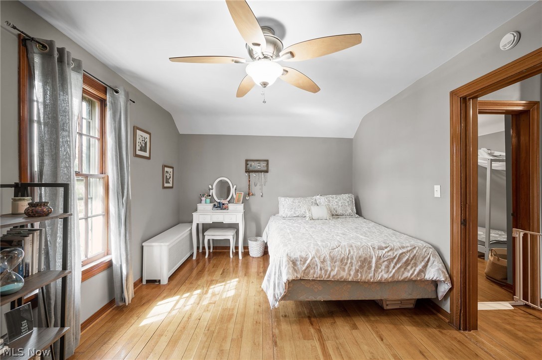 2420 Copley Road Akron, OH 44321 - Photo 25 of 44 Bedroom with ceiling fan, light hardwood / wood-style floors, radiator, and multiple windows