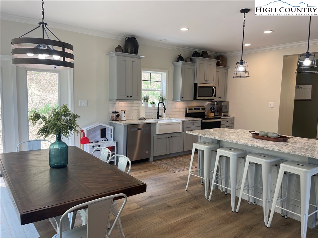 878 Ballou Farm Road Crumpler, NC 28617 - Photo 20 of 45 a kitchen with a table chairs and white cabinets