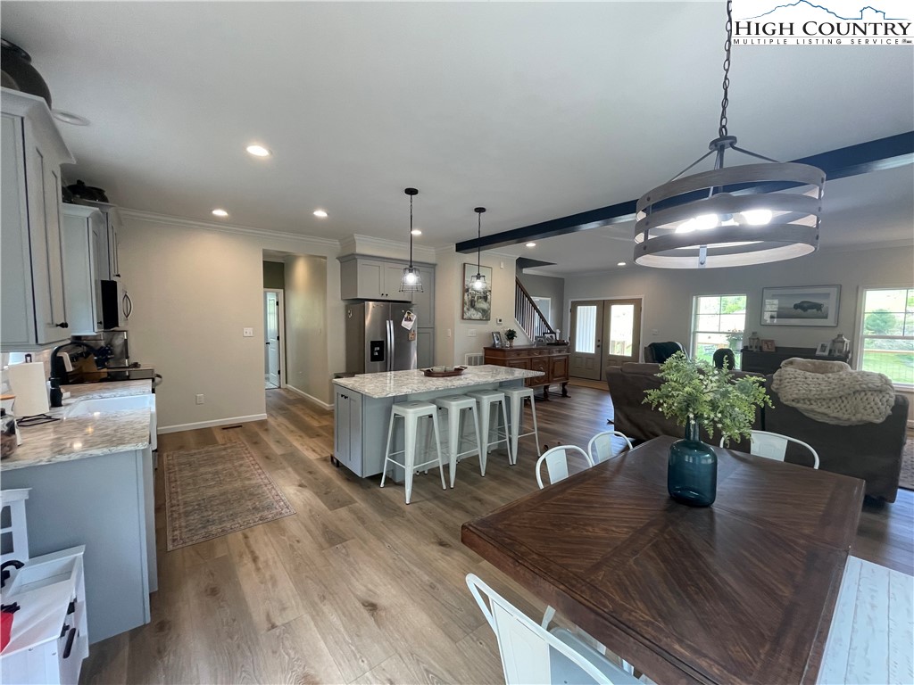 878 Ballou Farm Road Crumpler, NC 28617 - Photo 21 of 45 a view of a dining room with furniture a potted plant and wooden floor