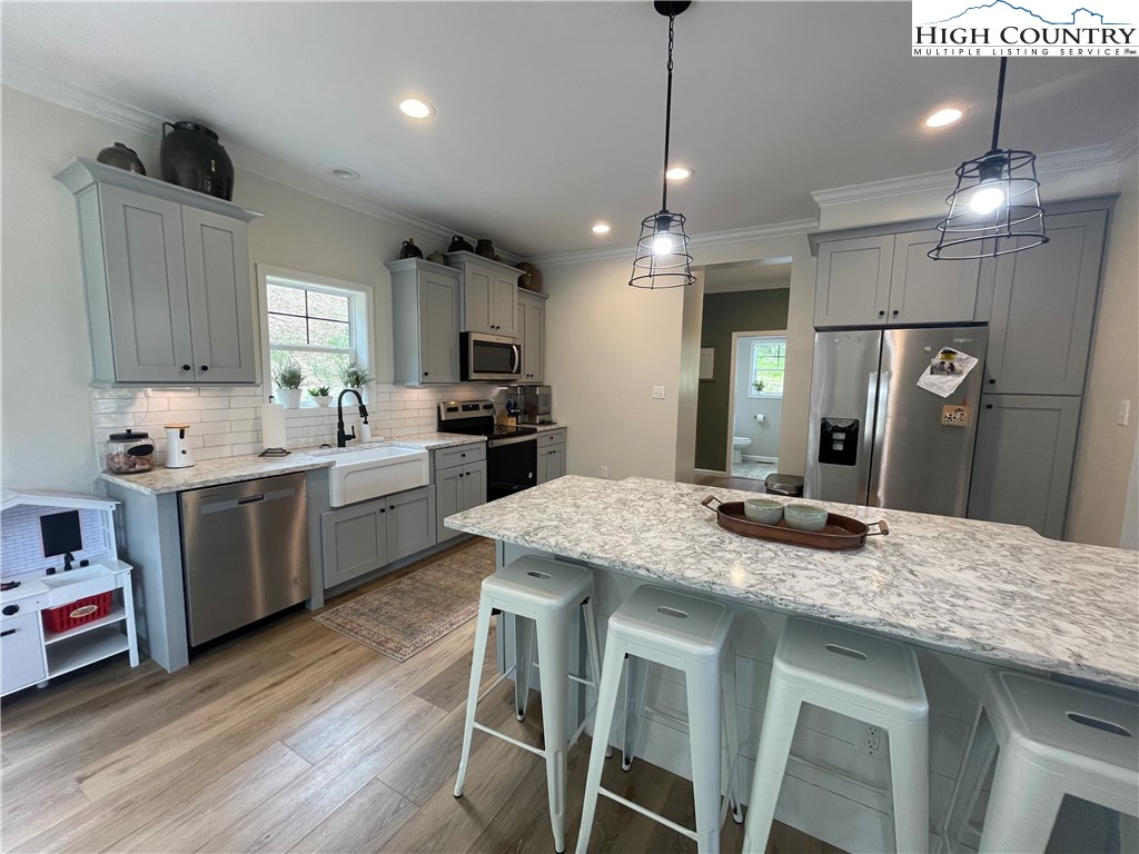 878 Ballou Farm Road Crumpler, NC 28617 - Photo 23 of 45 a kitchen with granite countertop a sink stove and refrigerator