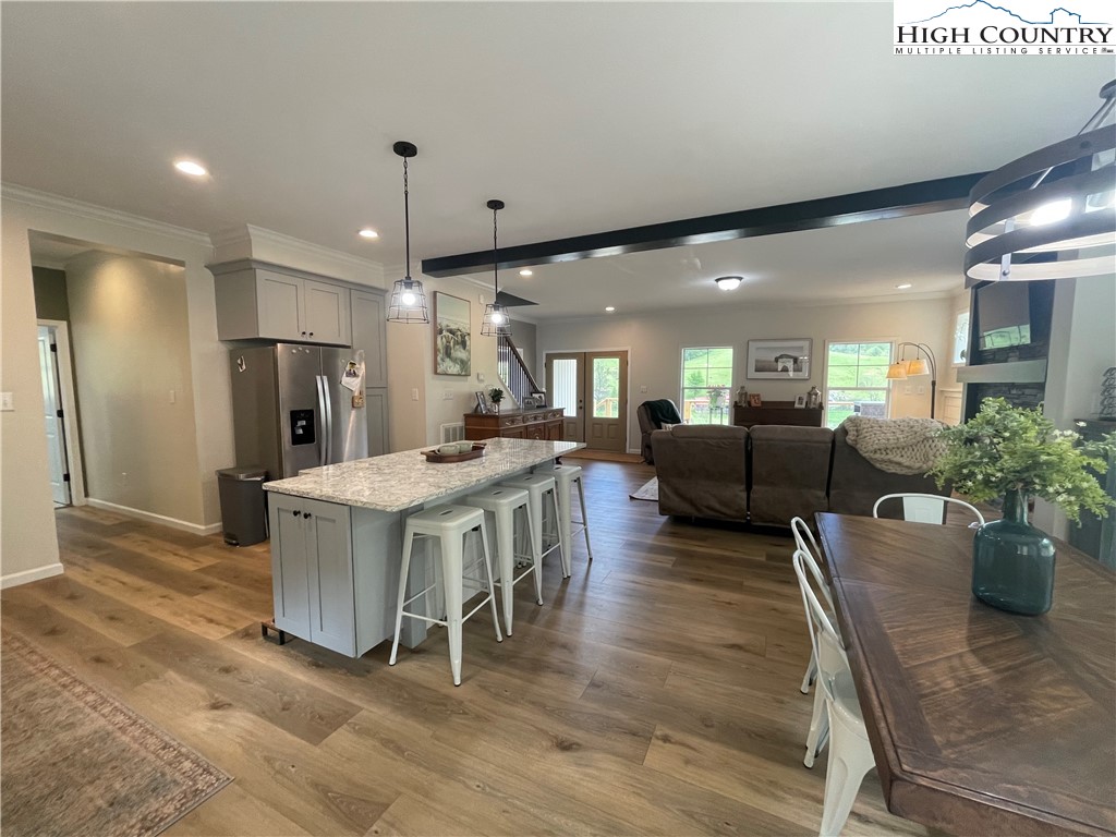 878 Ballou Farm Road Crumpler, NC 28617 - Photo 26 of 45 a kitchen with stainless steel appliances kitchen island granite countertop a table chairs and a refrigerator