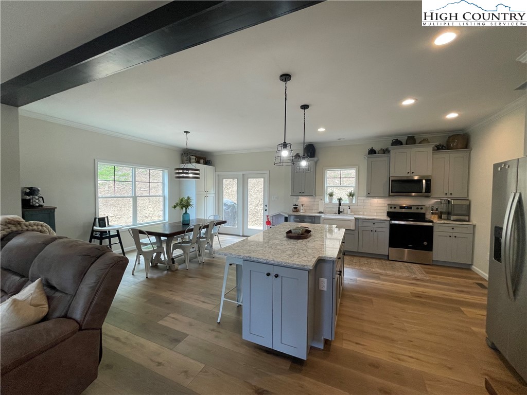 878 Ballou Farm Road Crumpler, NC 28617 - Photo 27 of 45 a living room with stainless steel appliances kitchen island granite countertop furniture wooden floor and a kitchen view