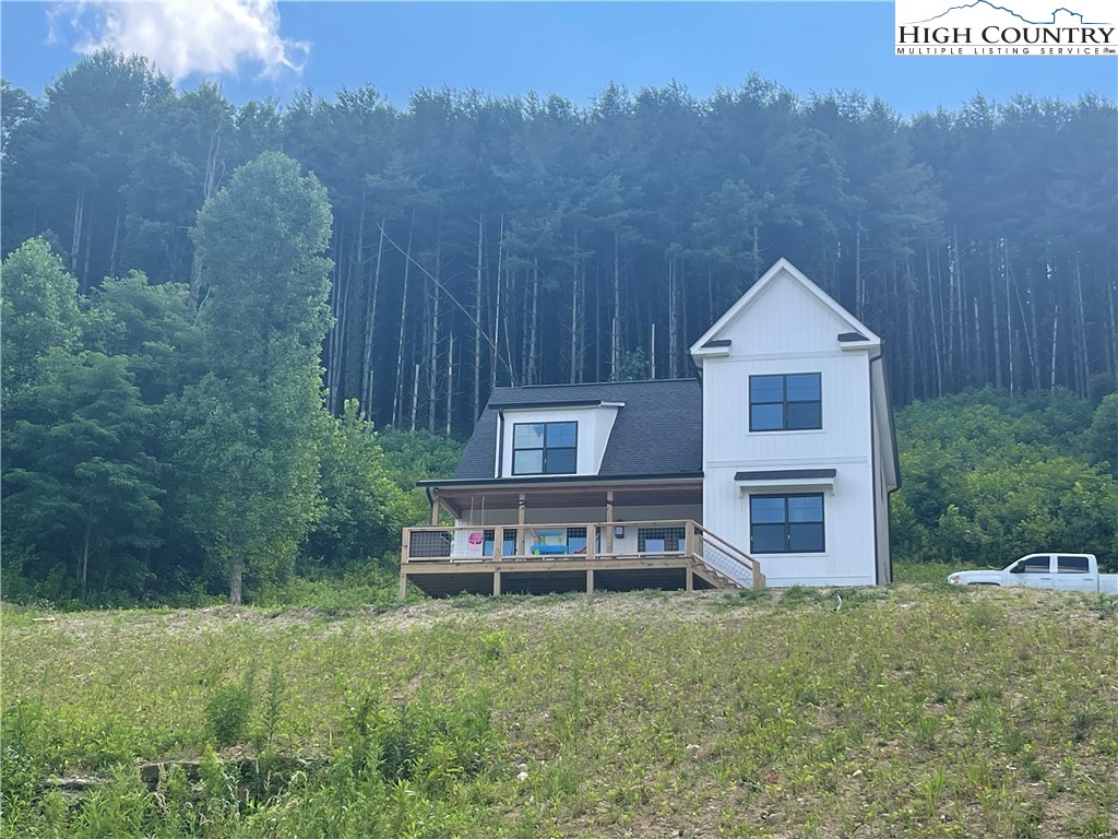 878 Ballou Farm Road Crumpler, NC 28617 - Photo 4 of 45 a view of a house with a yard and sitting area