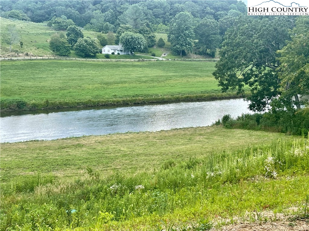 878 Ballou Farm Road Crumpler, NC 28617 - Photo 8 of 45 a view of a golf course with a lake