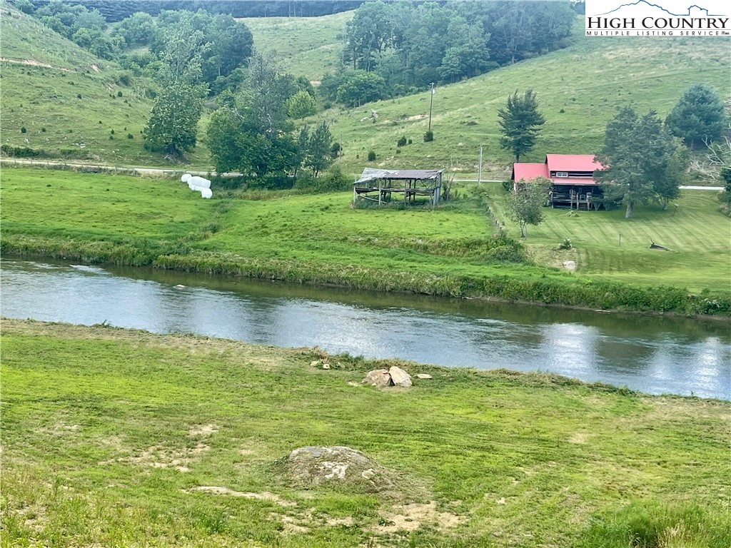 878 Ballou Farm Road Crumpler, NC 28617 - Photo 10 of 45 a backyard of a house with a yard and lake view