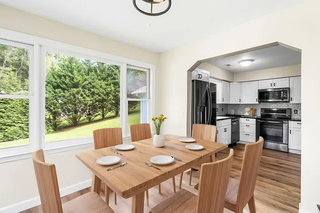a view of a dining room with furniture window and wooden floor