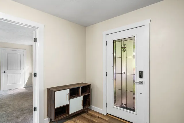 a view of front door with wooden floor