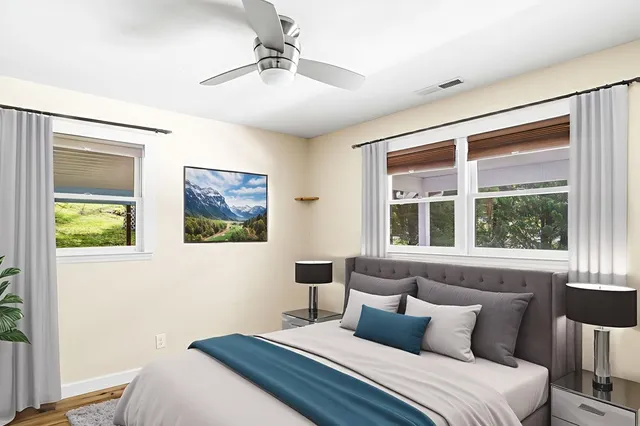 a bedroom with a bed and a window