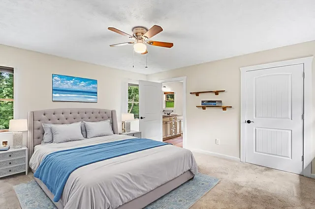a bedroom with a large bed and a chandelier