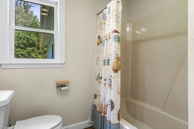 a bathroom with a toilet and shower