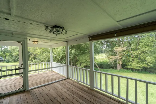 a view of a porch with wooden floor and outdoor space