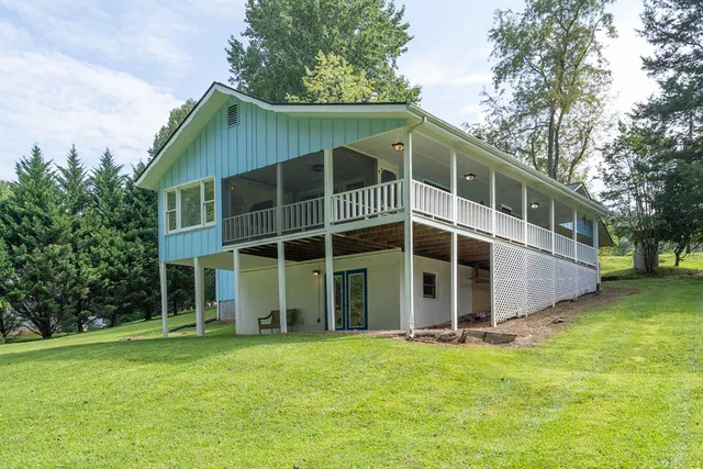a view of a lush green hillside and a houses