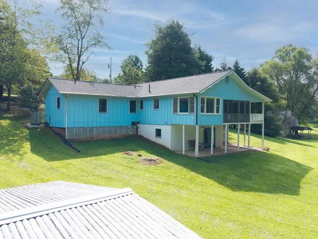 a view of a house with yard and sitting area