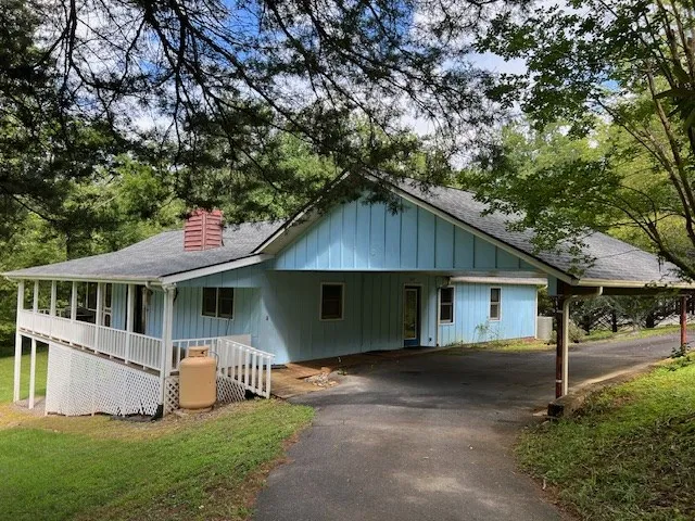 a house that has a tree in front of it