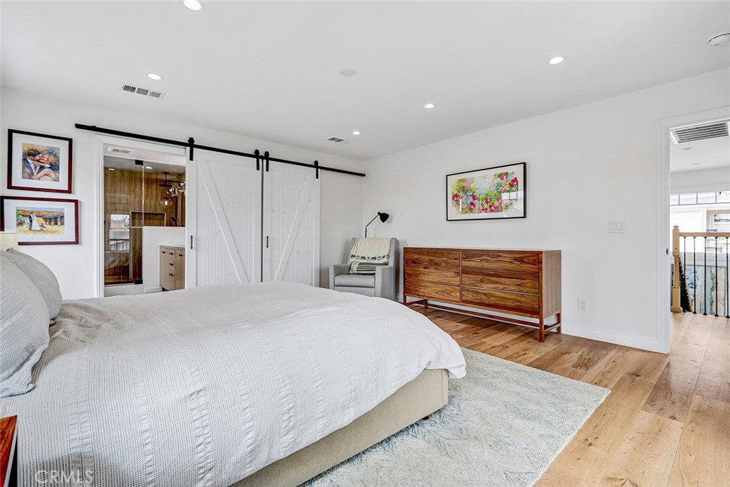 825 Center Street El Segundo, CA 90245 - Photo 21 of 52 a spacious bedroom with a bed and a flat screen tv