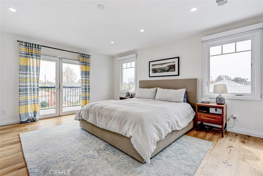 825 Center Street El Segundo, CA 90245 - Photo 23 of 52 a spacious bedroom with a large bed and a large window
