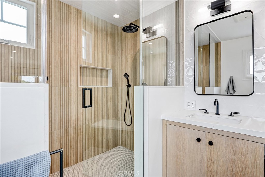825 Center Street El Segundo, CA 90245 - Photo 25 of 52 a bathroom with a double vanity sink mirror and shower
